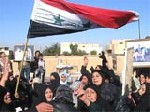 Almotamar Net - Iraqis wave the countrys flag and carry pictures of Saddam Hussein during a protest gathering in the Sunni stronghold of Tikrit, 130 kilometers north of Baghdad, Iraq, Jan. 3, 2007.