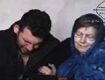 Almotamar Net - BAGHDAD � In the grainy footage, a pale woman in a blue veil clutches her weeping son and pleads for their lives.

